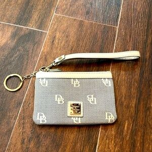 Black and white Dooney and Bourke wristlet with red leather inside